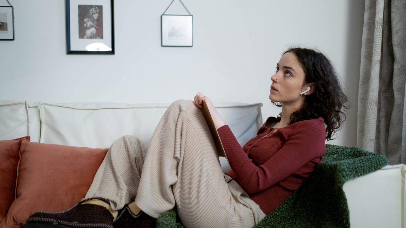 Woman sitting on a couch looking unsettled