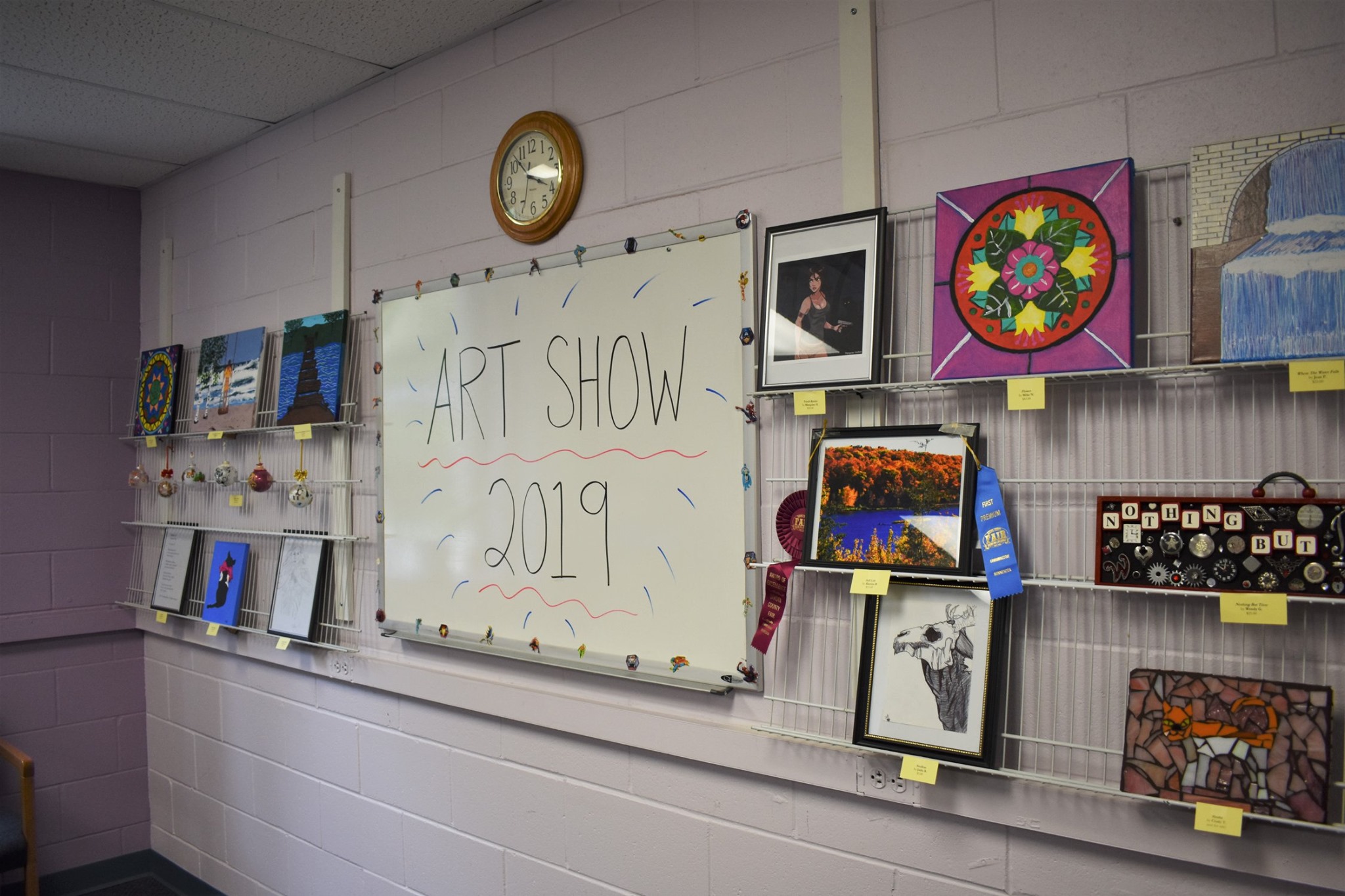 whiteboard with the words "Art show 2019" with art around it